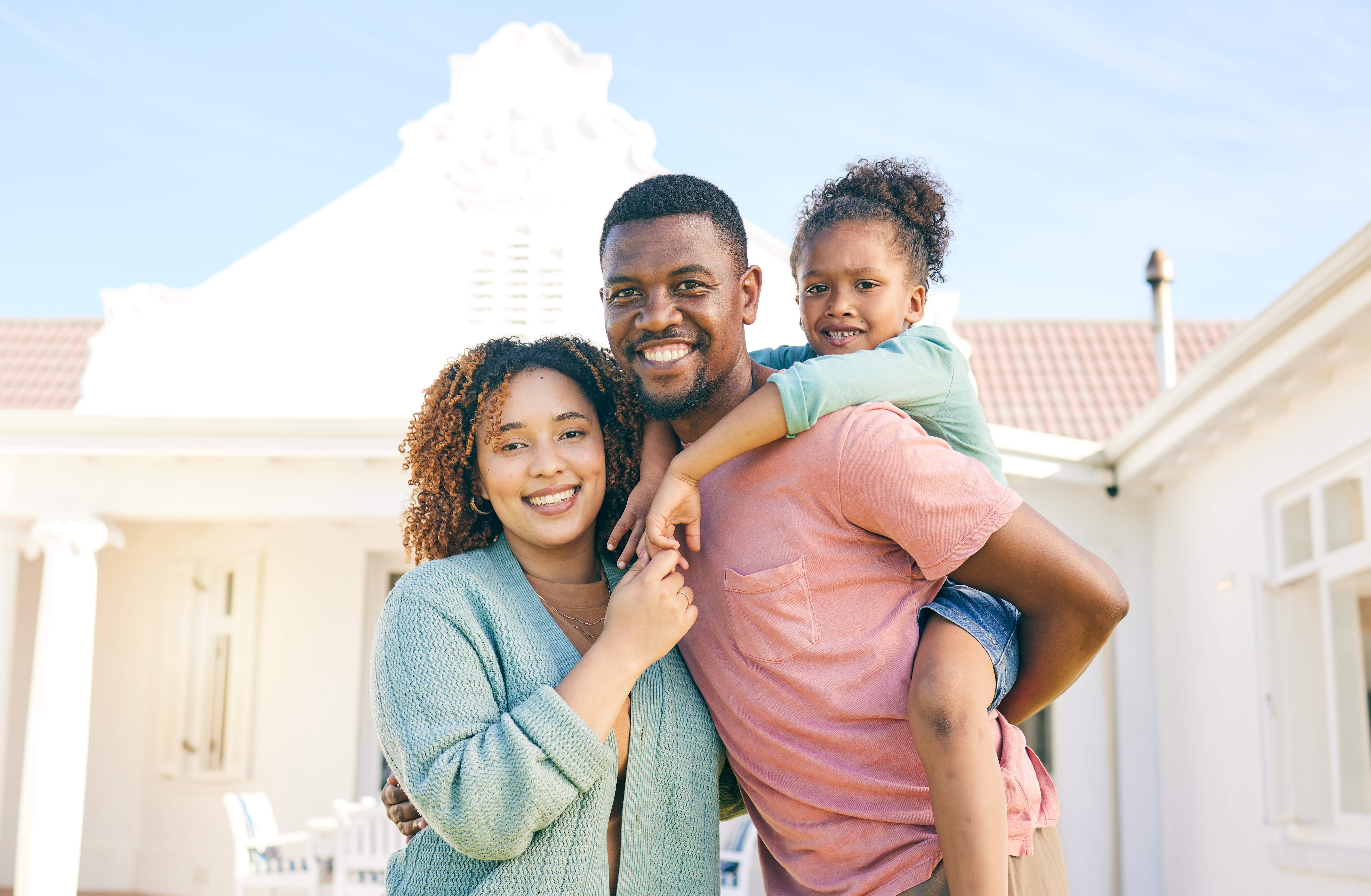 Happy family in front of their new home