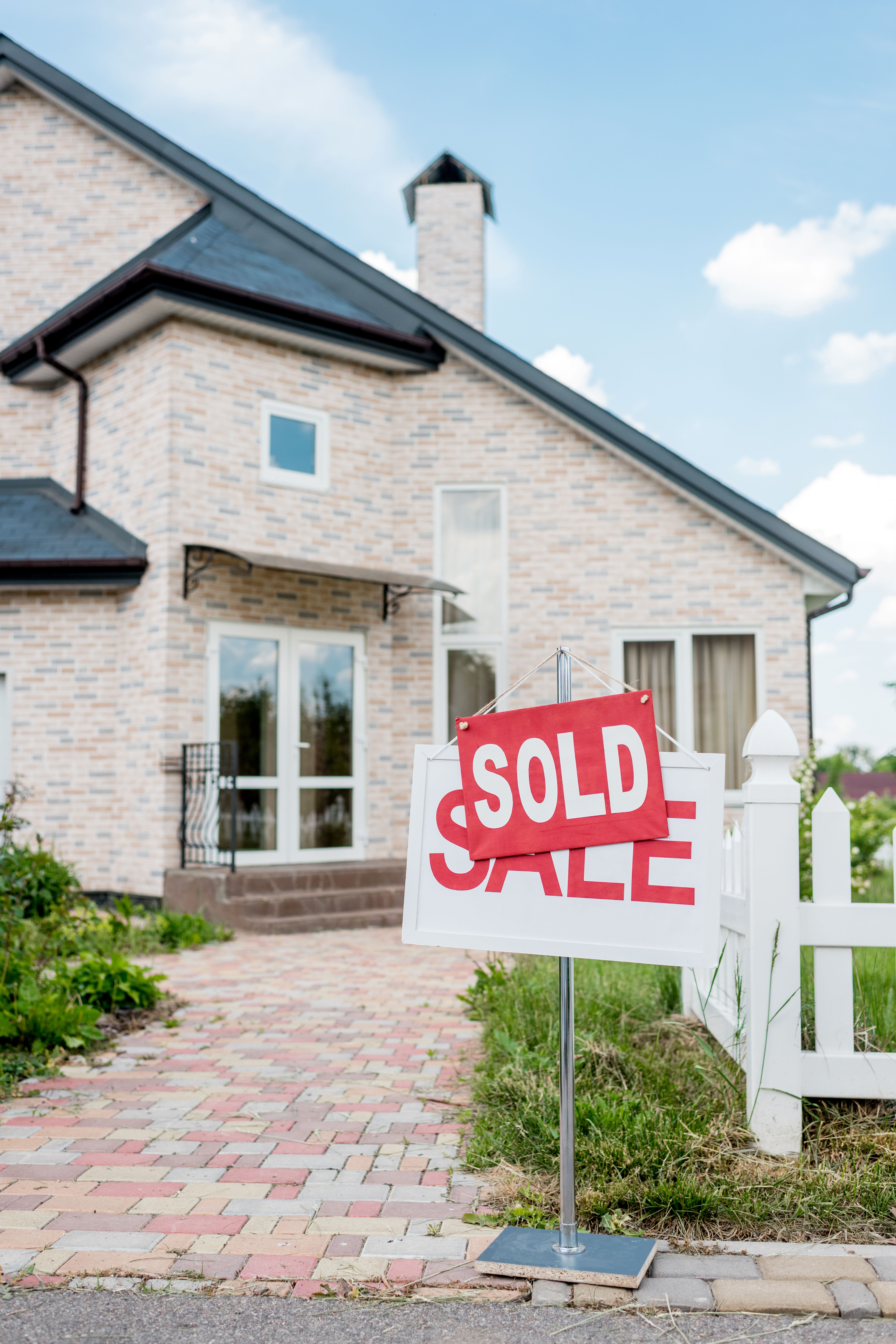 Charming suburban home with a Sold sign in the yard